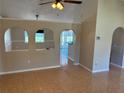 Open living room with tiled floors, archways, neutral walls and ceiling fan at 806 Grantham Dr, Kissimmee, FL 34758