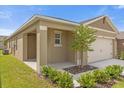 Charming one-story home featuring a covered porch, attached garage, and beautifully landscaped front yard at 957 King Parc Rd, Orange City, FL 32763