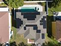 Aerial view of home featuring solar panels on the roof, and a private backyard pool at 7801 Belvoir Dr, Orlando, FL 32835