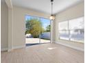 Bright room with wood-look floors, slider to the backyard, and a view of the outdoors at 7801 Belvoir Dr, Orlando, FL 32835