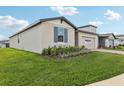 A well-maintained lawn and exterior of a single Gathering home in a residential neighborhood at 1390 Current Pl, Haines City, FL 33844