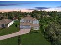 Beautiful aerial view of a gray home, nestled among lush greenery and well-manicured lawns in a quiet neighborhood at 708 Fox Edge Ct, Oviedo, FL 32765