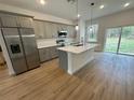Modern kitchen with stainless steel appliances, gray cabinets, and an island at 6807 Sw 153Rd Place Rd # 6807, Ocala, FL 34473
