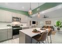 Open-concept kitchen with a large island, modern appliances, and stylish pendant lighting at 2524 Dellwood Dr, Orlando, FL 32806