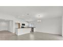Bright, open-concept kitchen featuring white cabinets, stainless steel appliances, and a granite breakfast bar at 3409 Narrows Dr, Lakeland, FL 33810