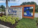 Attractive community sign for The Cove at Storey Lake featuring stone accents and a blue Adirondack chair design at 3161 Paradox Cir # 202, Kissimmee, FL 34746