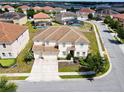Expansive two-story home with a three-car garage in a well-maintained community at 7001 Oakwood St, Davenport, FL 33837