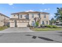 Elegant two-story home featuring a three-car garage and meticulously manicured landscaping at 7001 Oakwood St, Davenport, FL 33837