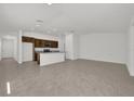 Open concept floor plan with a kitchen featuring dark wood cabinets and gray granite countertops at 8645 Caribbean Pine Way, Lakeland, FL 33809