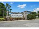Stone monument sign for Nova Grove with manicured landscaping and clear blue skies at 5200 Landmark Dr, St Cloud, FL 34771