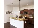 Well-lit kitchen featuring stainless steel appliances, granite counters, and wooden cabinets at 2652 Carrickton Cir, Orlando, FL 32824