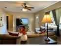 Comfortable living room featuring neutral walls, ceiling fan, and tile flooring at 3804 Janie Ct, Orlando, FL 32822