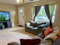 Inviting living room with tile floors, cozy seating, and lots of natural light at 3804 Janie Ct, Orlando, FL 32822