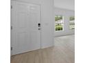 Bright entryway with light tile flooring, a white front door, and large windows offering pleasant views at 463 Shadow Gorge Way, Eustis, FL 32736