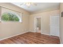Bright bedroom boasts hardwood floors, an arch window and access to the ensuite bathroom at 1611 Sand Key Cir, Oviedo, FL 32765