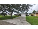 House exterior with a long driveway and green grass at 7438 Floral W Cir, Lakeland, FL 33810