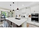 Modern kitchen featuring quartz countertops, an island with seating, and stainless steel appliances at 16161 Parkwyn St, Winter Garden, FL 34787