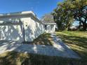 Beautiful home with a grey concrete driveway, nice lawn and a welcoming entrance at 4445 America St, Orlando, FL 32811