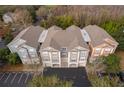 Aerial view of condo buildings with garages and neutral exteriors, surrounded by trees and parking areas at 12855 Madison Pointe Cir # 106, Orlando, FL 32821