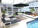 Relaxing screened-in pool patio with lounge chairs and dining set at 320 Henley Cir, Davenport, FL 33896