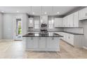 Beautiful kitchen with white cabinets, stainless steel appliances, and island with dark countertops at 1211 Teal Creek Dr, St Cloud, FL 34771