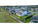 Aerial view of a house with a fenced backyard, neighboring houses, and lush green surroundings at 16744 Sanctuary Dr, Winter Garden, FL 34787