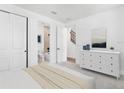 Bright bedroom featuring neutral walls, carpet, and ensuite bath access with a minimalist design at 2138 Whitney Marsh Aly, Orlando, FL 32804