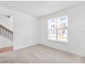 Neutral carpeted bedroom with a large window and bright natural light at 2138 Whitney Marsh Aly, Orlando, FL 32804