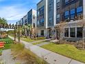 Modern townhome exteriors with sidewalks, landscaping, and pergola seating area at 2138 Whitney Marsh Aly, Orlando, FL 32804