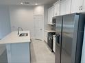 Modern kitchen with stainless steel appliances and an island at 366 Switchgrass Loop, Minneola, FL 34715