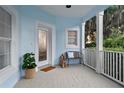 Cozy front porch featuring tile flooring, a small bench, and a decorative front door at 12428 Summerport Ln, Windermere, FL 34786