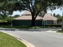 Charming single-story home boasts a well-maintained lawn, clay tile roof, and mature trees at 4559 Oak Arbor Cir, Orlando, FL 32808