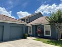 Charming single-story home boasts a well-maintained lawn, attached garage and clay tile roof at 4559 Oak Arbor Cir, Orlando, FL 32808