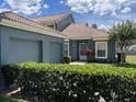 Charming single-story home boasts a well-maintained lawn, attached garage and clay tile roof at 4559 Oak Arbor Cir, Orlando, FL 32808