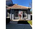 Charming one-story home with a tile roof, security door, neutral color, and well-kept landscaping at 4559 Oak Arbor Cir, Orlando, FL 32808