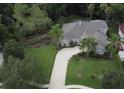 Expansive aerial view showcasing the home's large lot, mature trees, and meticulously manicured landscaping at 4901 Shoreline Cir, Sanford, FL 32771