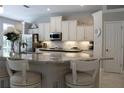 Bright and airy kitchen with white cabinetry, granite countertops, stainless steel appliances, and modern finishes at 4901 Shoreline Cir, Sanford, FL 32771