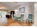 Bright dining area with glass table, chandelier, and hardwood floors at 5875 Talavera St, Orlando, FL 32807