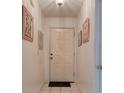 Inviting hallway features tiled flooring and decorative wall art at 5875 Talavera St, Orlando, FL 32807