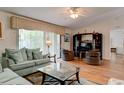 Bright living room with comfortable sofas, hardwood floors, and entertainment center at 5875 Talavera St, Orlando, FL 32807