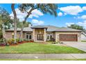 Brick house with landscaped yard, double door entry, and a wood garage door at 250 Shady Oaks Cir, Lake Mary, FL 32746