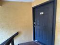 Close up of the front door to a home, featuring a black door with silver hardware at 4642 Commander Dr # 933, Orlando, FL 32822