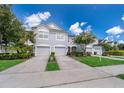 Gray townhomes with attached garages and lush green lawns at 15223 Windmill Harbor Ct, Orlando, FL 32828