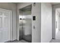 Interior view of an elevator in the condo building with doors and signage at 1401 Celebration Ave # 402, Celebration, FL 34747