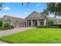 Two-story house with a three-car garage and a landscaped lawn at 6533 Cartmel Ln, Windermere, FL 34786