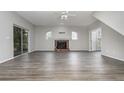 Spacious living room with fireplace, wood-look floors and sliding glass doors at 105 James Pond Ct, Debary, FL 32713