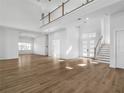 Open concept living room, hardwood floors, high ceilings, and natural light at 15023 Pendio Dr, Montverde, FL 34756