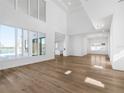 Spacious living area with hardwood floors, high ceilings, and pool view at 15023 Pendio Dr, Montverde, FL 34756