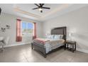 Bright bedroom with ceiling fan and large windows at 325 Daffodil Ln, Kissimmee, FL 34759