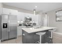 Modern kitchen with stainless steel appliances and a large island at 325 Daffodil Ln, Kissimmee, FL 34759